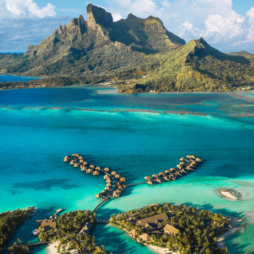 Mount Otemanu at the horizon with aerial view of the lagoon and resort